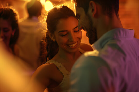 A couple smiling in a dance class or party.