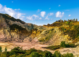 landscape of Plegrean volcano fields in Naples Italy near Pompeii with sulfur yellow caldera duribg eruption of smoke. campi Flegrei and cataclysm of Earthquake