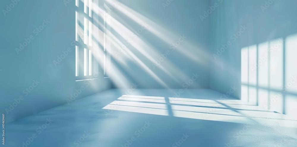 Poster light and intricate shadows cast by a window on a wall create a minimal abstract light blue backgrou
