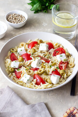 Orzo pasta with white cheese, tomatoes and olives. Healthy eating. Vegetarian food.