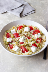 Orzo pasta with white cheese, tomatoes and olives. Healthy eating. Vegetarian food.