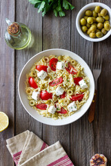 Orzo pasta with white cheese, tomatoes and olives. Healthy eating. Vegetarian food.