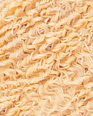 Close-up of dry Asian instant noodles. Texture of raw noodles without spices and condiments. 