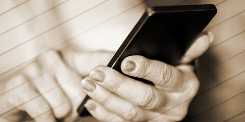 Woman's hands using a mobile phone, geometric pattern
