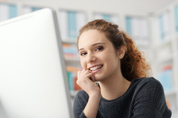 Young beautiful woman connecting with her computer