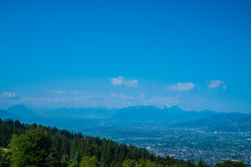 Austria, Panorama nature landscape mountain view from peak of pfaender above tree tops to saentis peak with snow in summer and blue sky
