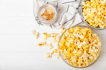 Tasty popcorn on woodenbackground. Cinema and entertainment concept. Movie night with...