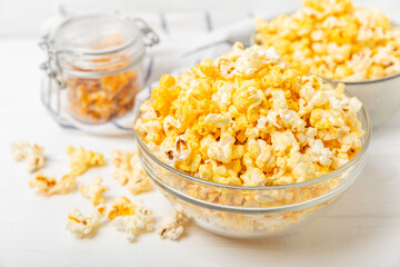 Tasty popcorn on woodenbackground. Cinema and entertainment concept. Movie night with popcorn.Cheese and caramel popcorn. Delicious appetizer, snack. Place for text. Copy space.Banner