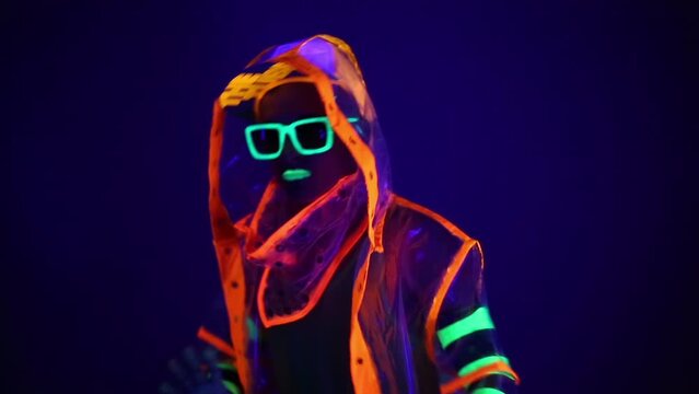 Man is dancing in neon clothes close up