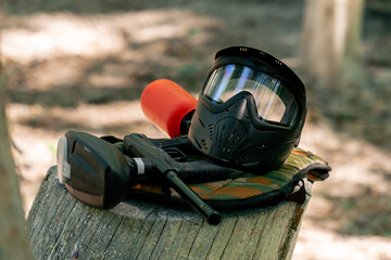 close-up of the wild nature on a wooden lacquered table there is ammunition pintball gun active...