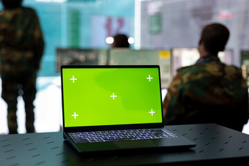 Laptop showing isolated green screen in military power base, federal defense personnel working on...