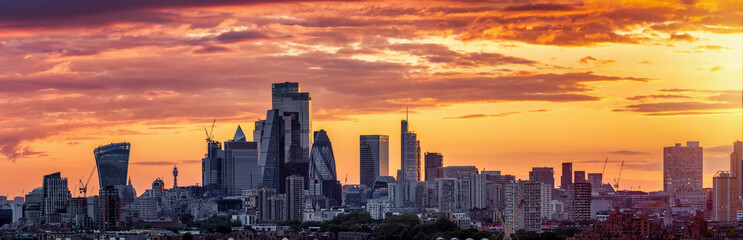 Panorama of the urban London City skyline during a colorful summer sunset, England