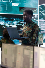 Intelligence analyst technician coordinating air support to provide assistance for ground troops,...