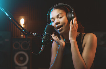 Woman recording an audio track in the studio