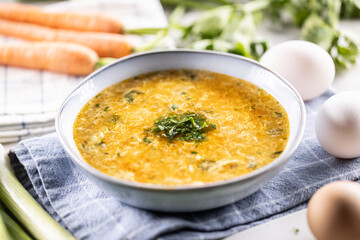 Egg and carrot soup in a bowl. Traditional Slovak egg and carrot soup