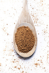 Coconut palm sugar in coconut bowl isolated on white backgroundCoconut palm sugar on a wooden spoon isolated on white background