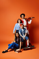 Multicultural friends, including a nonbinary person, pose in stylish attire in a studio setting.