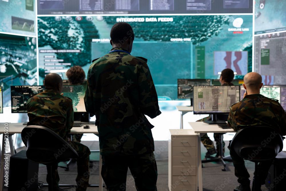 Poster infantry unit trooper analyzing intelligence gathered from satellite system, military command post a