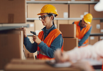 Warehouse worker scanning a barcode on a box