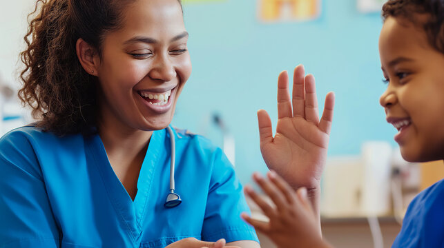 A pediatric nurse playing a hand-clapping game with a smiling child in a hospital ward, creating a joyful atmosphere.