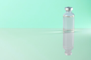 medical bottle of injectable medication in a pharmaceutical laboratory blue background copy space