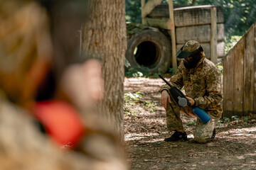 in the wild near fences players play pintball team competitions in a special uniforms victory over...