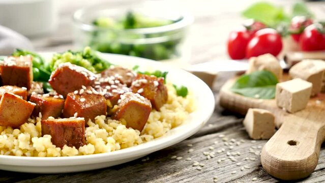 vegan meal dish- place with bulgur, grilled tofu and vegetable
