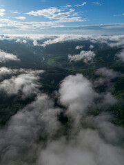 A high-angle landscape, dense fog, natural forest mountains covered in fog. A bright sky and beautiful landscape can be viewed from the sky with a drone.