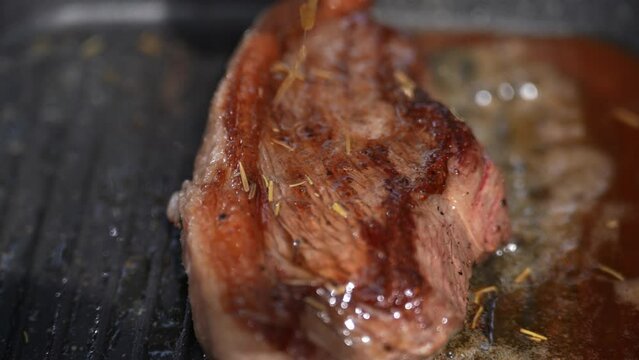 Make a Butter Basting brown Steaks on a hot pan,Close up.