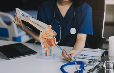 Portrait of young female doctor cardiologist working in office of modern clinic