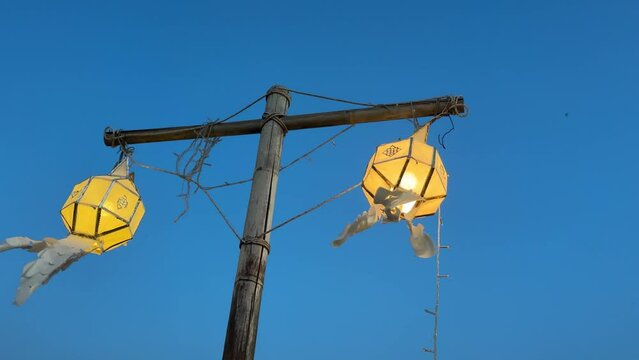 Glowing Chinese lanterns hanging on a pole