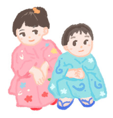 浴衣を着てしゃがんでいる姉と弟