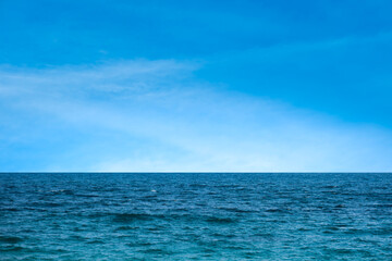 Ocean background and sea water and clear sky. For summer vacation ideas The nature of the beach and summer sea with the sun shining on the sea sparkling against the blue sky.	