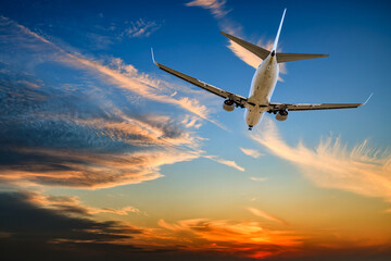 Commercial airliner and cloudscape at sunset. Travel background