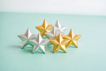 Obraz premium Gold and Silver Stars on a Mint Green Background
