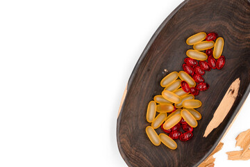Medicine and healthcare, multicolored healing pills of vitamins and medicines in beautiful wooden table on white background, top view, with empty space