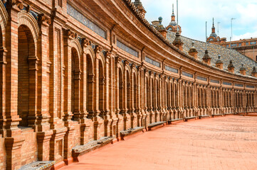 Fototapeta premium Architectural perspective of the ancient part of a red brick building located in Seville's Spanish Square