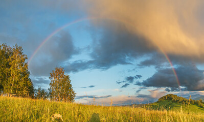 Sunset light and rainbow, rural highlands