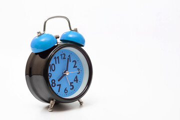 Blue alarm clock on a white background, close-up. Side view.