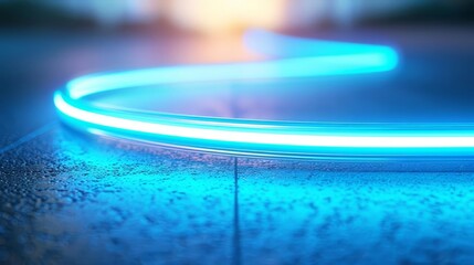 Abstract blue neon light trail on a dark background.