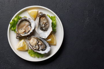 Fresh oysters with lemon on plate