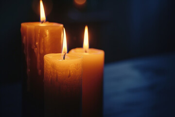 Three candles are burning, creating a romantic ambiance with their warm, flickering light