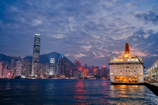 Cruise lener ship in Hongkong harbor. Nightscape and Skyline of Urban Architecture in Hong Kong.
