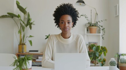 Confident woman working on laptop in cozy home office surrounded by plants, exuding serenity and focus.