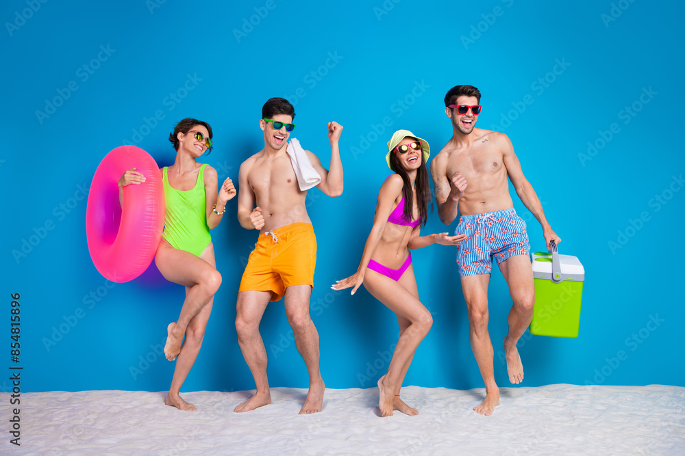 Wall mural full length photo of positive lucky fellows company wear swimsuits enjoying weekend together isolate