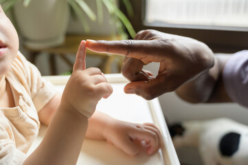Teaching moment between African American man and Caucasian child