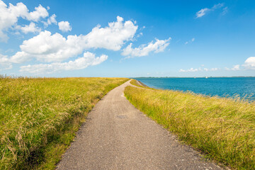 Cycling and walking path along the Dutch estuary Oosterschelde. The photo was taken on a sunny day at the end of the spring season.