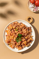 Jambalaya with rice chickpeas and kidney beans on beige table