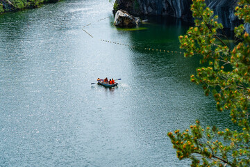 Rowboat on Tranquil Lake with Rocky Shoreline in Karelia