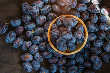 Plum variety Hungarian. Fruit harvest on the table in the kitchen. Autumn blue plum. Vitamin food bowl.